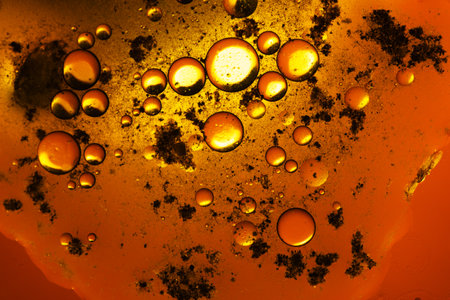 Abstract background with liquid and drops over a blurred backdrop, close up.の写真素材