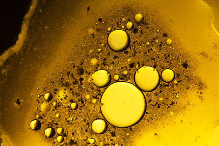 Abstract background with liquid and drops over a blurred backdrop, close up.の写真素材