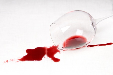 Spilling red wine on the tableclothの写真素材