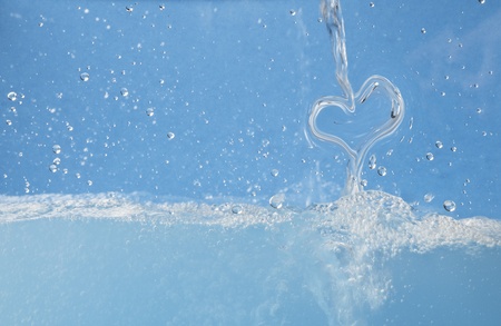 Water heart is splashing into the waterの写真素材