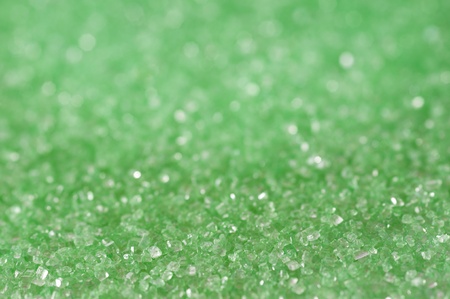 Green sugar sparkle background with focus in the frontの写真素材