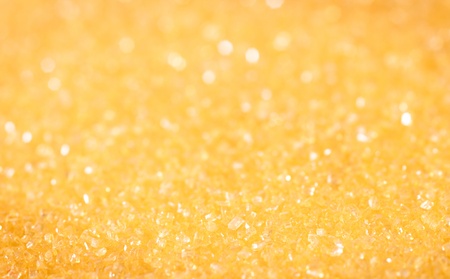 Yellow sugar sparkle background with focus in the frontの写真素材