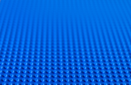 Lego blue baseplate. The Lego toys were originally designed in the 1940s in Denmark and have achieved an international appeal.のeditorial素材