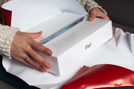 Unwrap a christmas or birthday gift and receive an iPad 3のeditorial素材