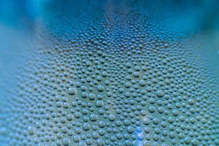 Water drops on a bottle with selectiv focus.