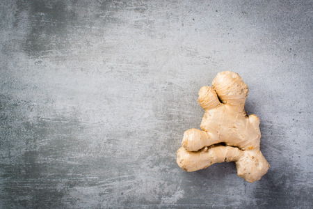 Hole ginger root on concrete background