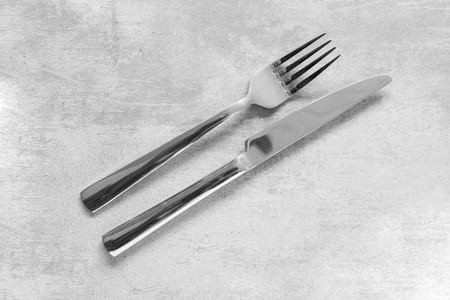 Fork and knife on a concrete table