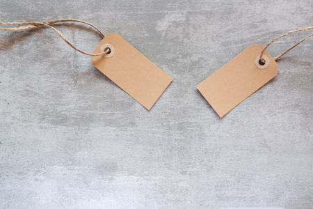 Gift tags made from recycled paper with string on concrete backgroundの写真素材