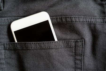 Close up of smartphone in back pocket on black pantsの写真素材