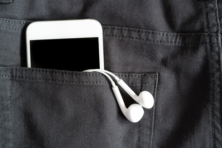 Close up of smart phone in back pocket on black pantsの写真素材