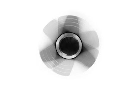 Hand spinner. A fidget toy for increased focus, stress relief on white backgroundの写真素材