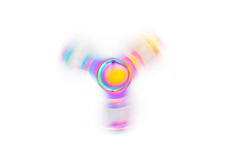 Hand spinner. A fidget toy for increased focus, stress relief on white backgroundの写真素材