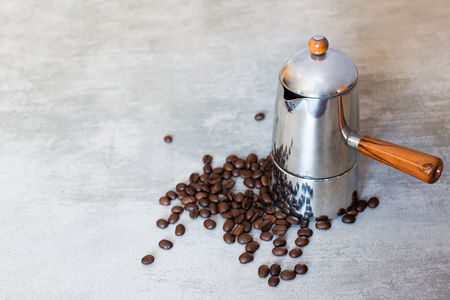 Italian coffee maker and coffee beans on concrete backgroundの写真素材