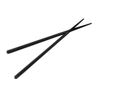 Pair of black chopsticks on white backgroundの写真素材