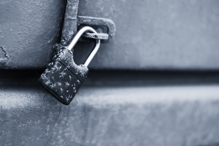 a locked lock with ice and snow outsideの写真素材