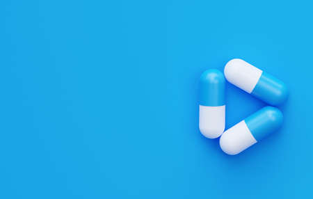 Three pills in the shape of a triangle on a blue background with an empty space. 3d rendering....