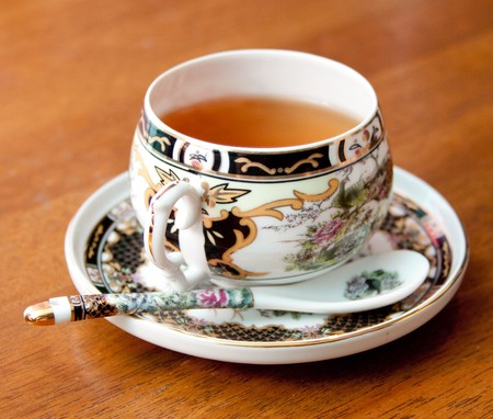 Black tea in an ornate china cupの写真素材