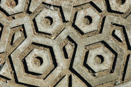 Closeup of a rusted and dirty manhole coverの写真素材