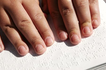 Blind person reading Bible written in Brailleの写真素材