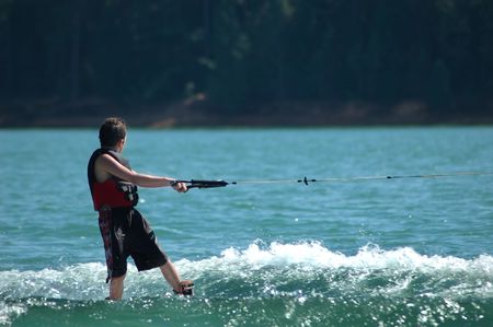 Kid wakeboarding on a lakeの写真素材