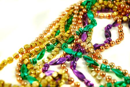 Strands of Mardi Gras beads isolated on a white backgroundの写真素材