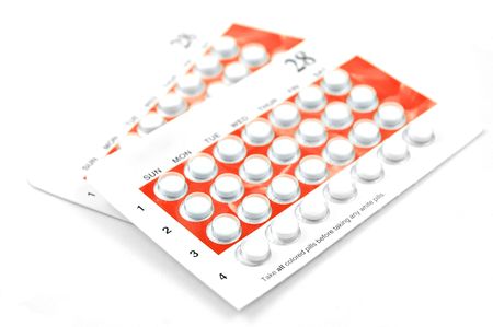 Two packages of birth control pills isolated on white