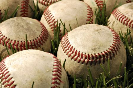 Nostalgic baseballs in the grass on a baseball field の写真素材