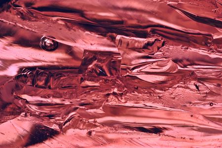 Macro of a large chunk of broken pink glassの写真素材