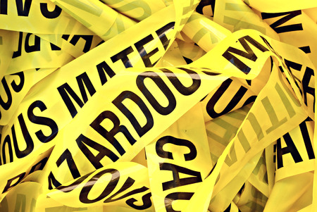 Pile of yellow plastic tape marked Cautious Hazardous Materialの写真素材