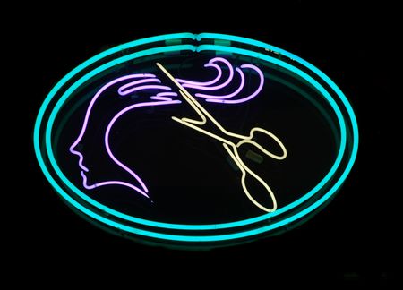 Illuminated scissors cutting long hair neon signの写真素材