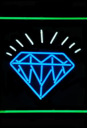 Illuminated sparkling diamond neon sign on blackの写真素材