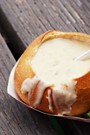 Clam chowder in a sourdough bread bowl on a wooden fishing dockの写真素材