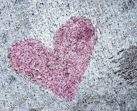 A heart shape hand formed on dried cementの写真素材