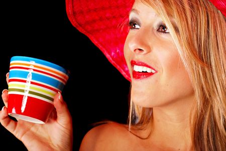 Blonde teenaged girl drinking coffee from ceramic cupの写真素材