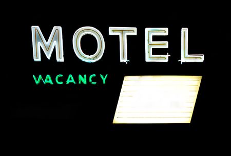 Motel and vacancy neon signs with message board isolated on black backgroundの写真素材