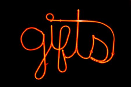 Red gifts neon sign isolated on black backgroundの写真素材