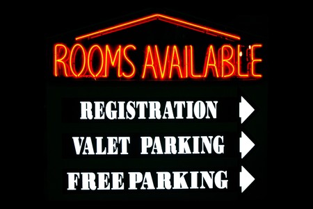 Rooms Available neon sign with parking directions at a hotelの写真素材