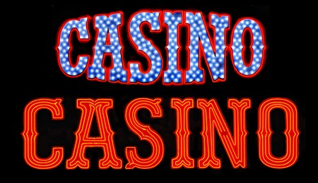 Two casino neon signs isolated on black backgroundの写真素材