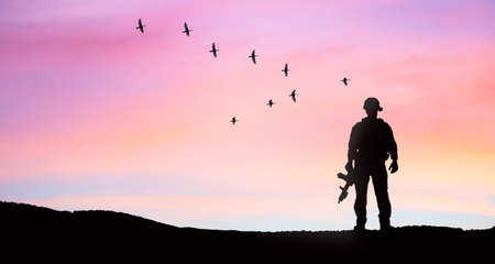 soldier silhouette on sunset sky background war peace conceptの写真素材