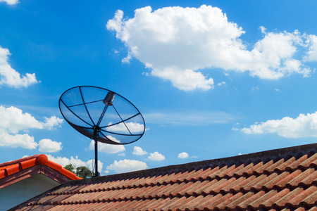 Satellite dish and TV antennas on the house roofの写真素材