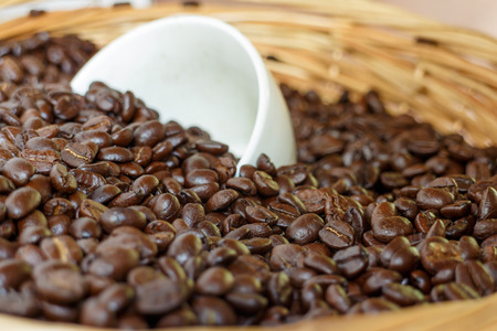roasted coffee beans, in brown basket soft focus, focus on coffeeの写真素材