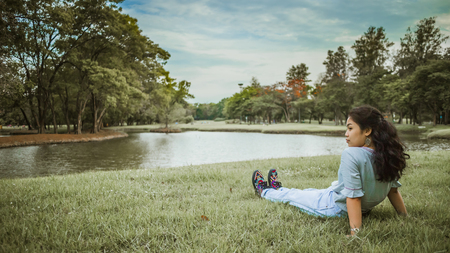 portrait asian woman sitting in park, with vintage toneの写真素材