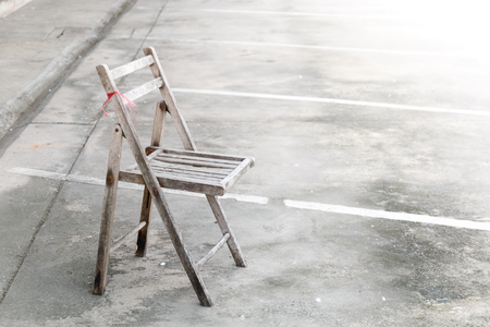 wooden old chair on parking and lighting effect backgroundの写真素材