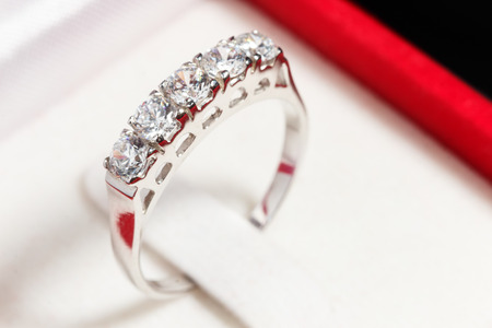 close up silver diamond ring in red ring boxの写真素材