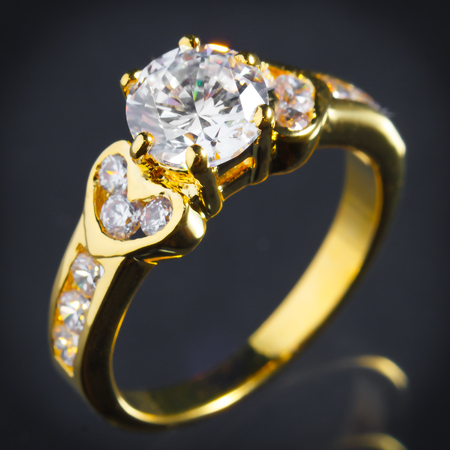 close up gold diamond ring on gray background, vignette effectの写真素材