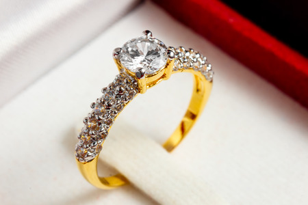 close up gold diamond ring in red ring boxの写真素材