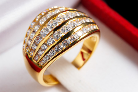 close up gold diamond ring in red ring boxの写真素材