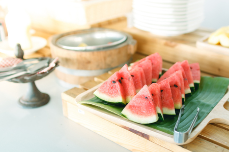 close up piece of watermelon in wooden dish on tableの写真素材