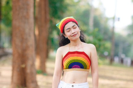 close up beauty asian woman on blur forest background with colorful wearの写真素材