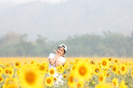 beauty asian woman stading in sunflowers field, traveling lifestyleの写真素材